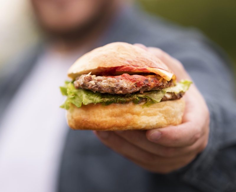 close-up-blurred-man-holding-burger